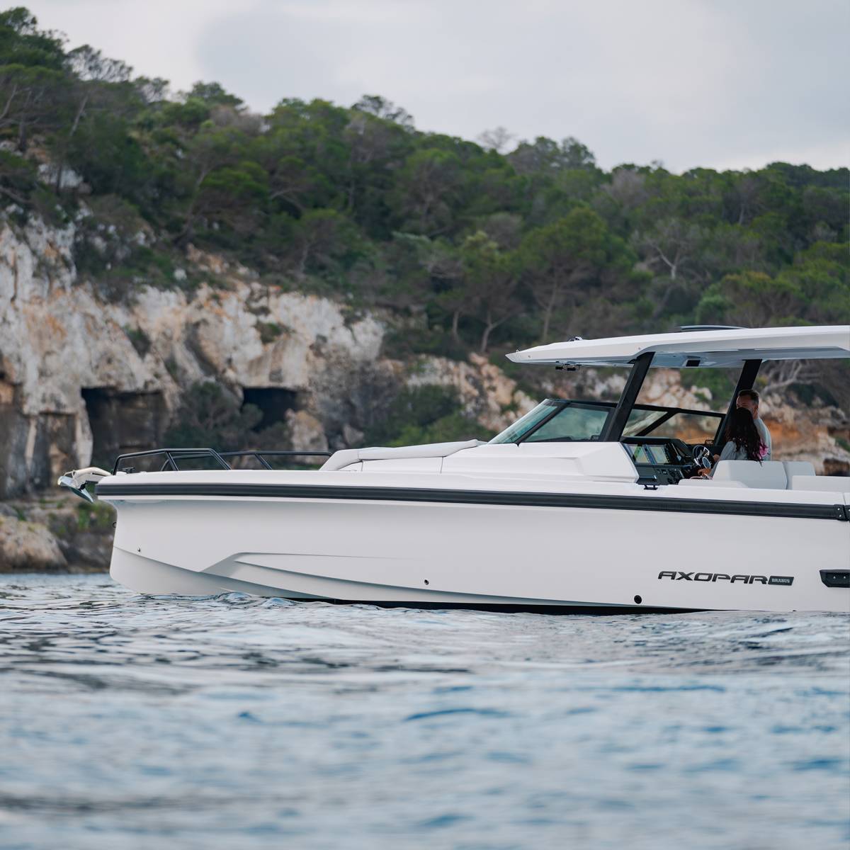Axopar 38 Sun-Top profile along a rocky coastline