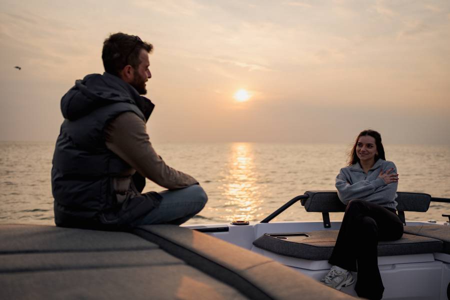 Couple relaxing on the aft deck at sunset